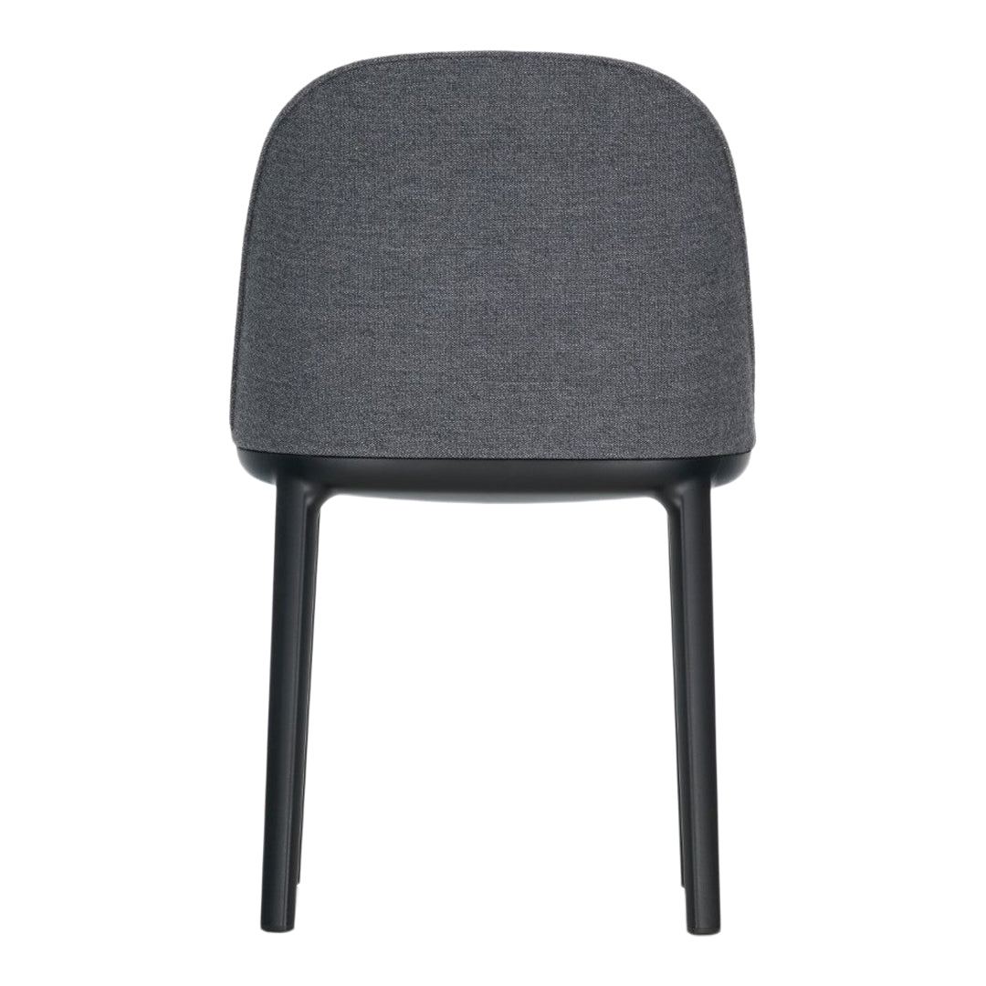 Gray upholstered chair with a smooth, minimalist design and black legs, perfect for modern interiors.
