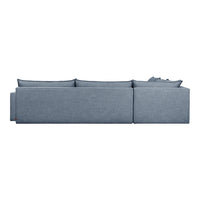 Blue fabric sectional sofa with a textured, subtle pattern, featuring loose back cushions and a modern design.