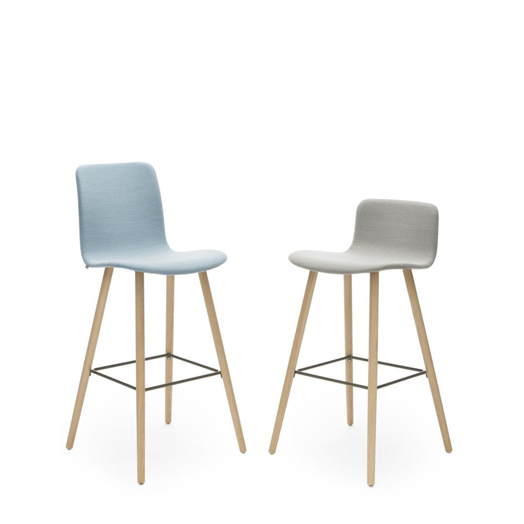 Light blue and gray upholstered bar stools with natural wood legs, minimalist design, and sleek lines.