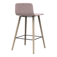 Pink upholstered stool with natural wood legs and a sleek black metal footrest, featuring a minimalist design.