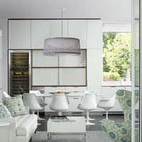 Modern dining room featuring a gray striped pendant lamp, white furniture, and green patterned accents.