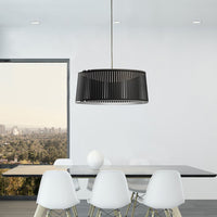 Modern black hanging light fixture with a sleek, ribbed pattern, enhancing contemporary dining spaces.