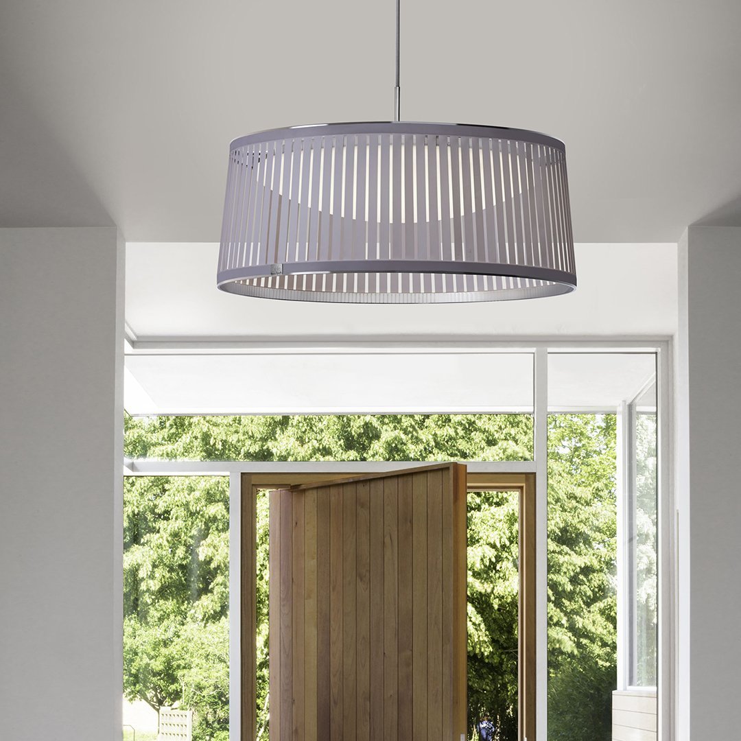 Gray striped pendant light casting soft shadows in a modern entryway with natural greenery in the background.
