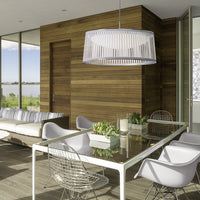 Modern dining area featuring white furniture, wood accents, and a sleek, patterned pendant light. Bright and airy design.