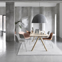 Stylish dining room with a gray and beige color palette, featuring patterned chairs and a textured pendant light.