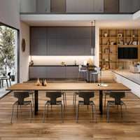 Modern kitchen with a warm wood table, gray cabinetry, and subtle lighting accents, featuring a cozy, minimalist design.