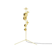 Gold floor lamp with a sleek design, featuring various circular patterns and a modern tripod base.