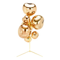 Sculptural metallic decor in gold with smooth, rounded shapes and reflective surfaces. Perfect for modern interiors.