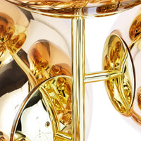 Reflective gold and copper metallic finish with smooth, rounded shapes and intricate light reflections.