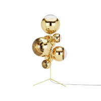 Gold metallic lamp with spherical shapes, featuring a polished finish that reflects light beautifully.