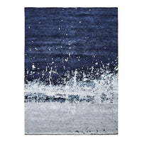 Navy blue and gray abstract area rug with a textured pattern and splashes for a modern touch.