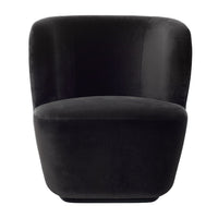 Black velvet accent chair with a smooth, curved design, perfect for modern decor.