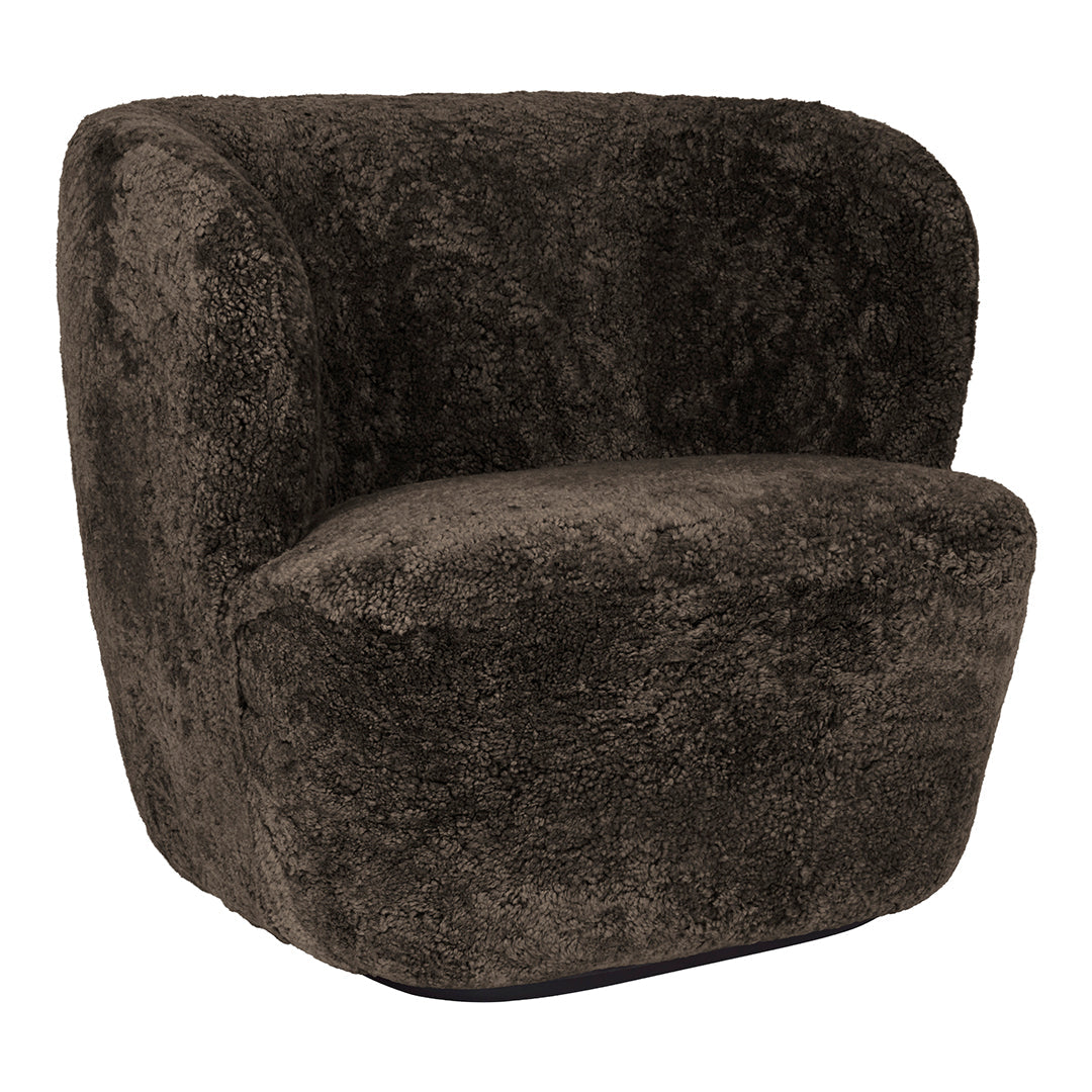 Soft, plush charcoal gray armchair with a rounded silhouette and textured fabric, perfect for modern decor.