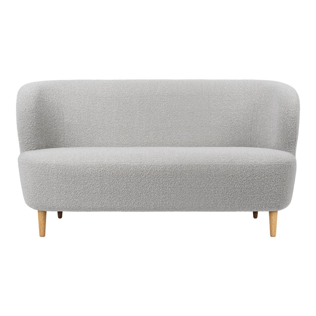 Light gray upholstered sofa with a smooth, textured pattern and natural wood legs. Modern and stylish design.