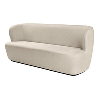 Beige upholstered sofa with a smooth, minimalist design and curved arms, featuring a solid, neutral color.