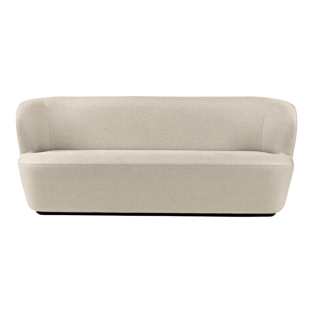 Beige curved sofa with a smooth, minimalist design and no visible patterns. Elegant and modern furniture piece.