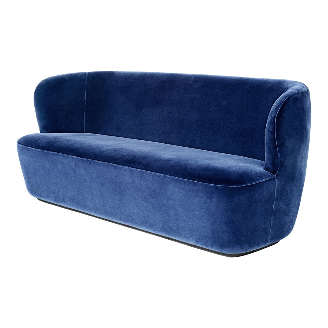 Luxurious navy velvet sofa with smooth, curved design and minimalistic modern aesthetic. Perfect for stylish interiors.