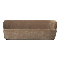 Soft beige sofa with a textured, minimalist design; features rounded edges and subtle, luxurious fabric.