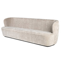 Beige sofa with a smooth texture and curved design, featuring a minimalist style and subtle elegance.