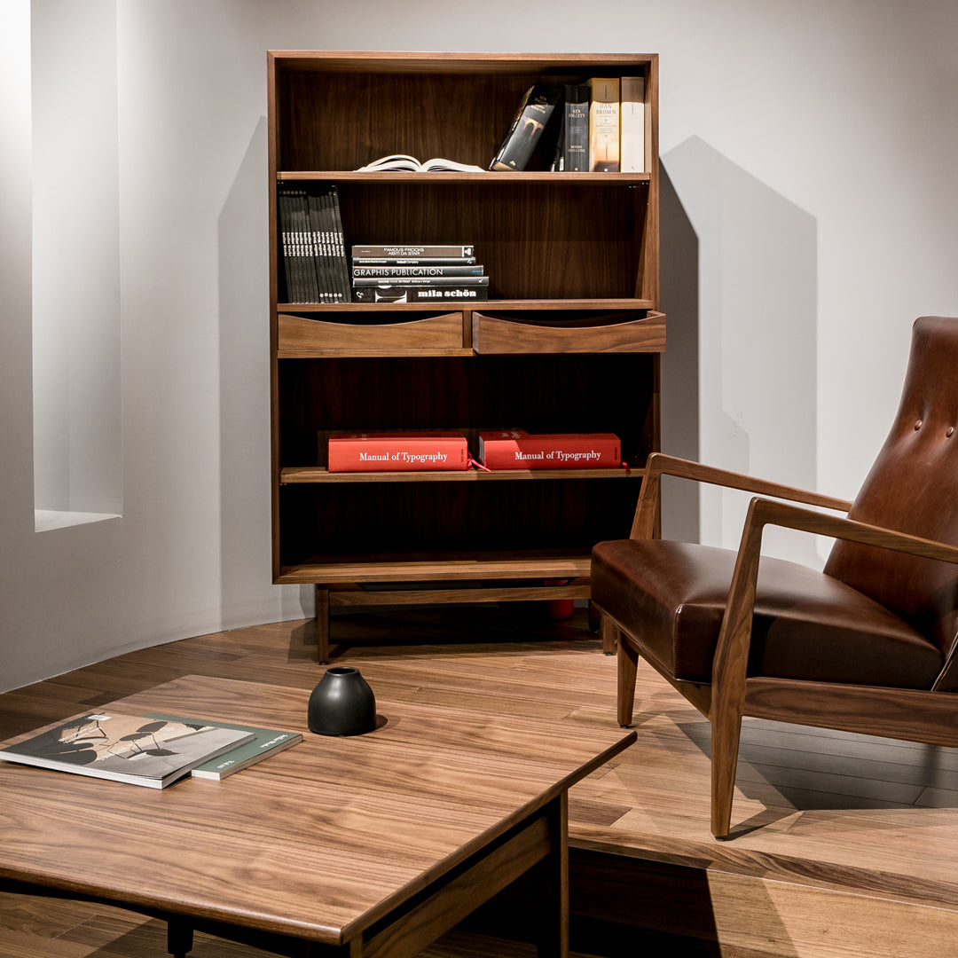 Mid-century modern bookshelf in rich walnut finish, featuring sleek lines and open shelving. Warm wood tones with a minimalist design.