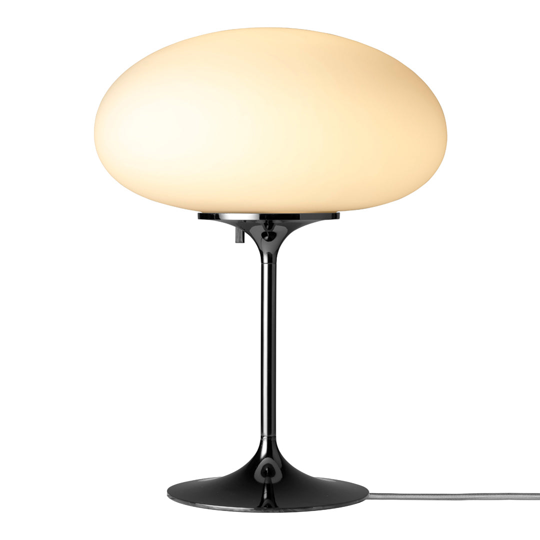 White oval lamp shade on a sleek black base, creating a modern, minimalist aesthetic for any space.