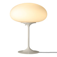 Soft white lamp with a smooth, round shade and sleek gray base, ideal for modern decor.