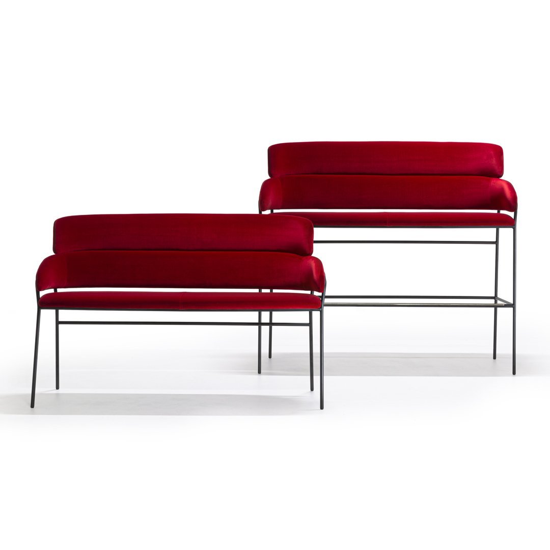 "Set of two sleek benches featuring rich red upholstery and minimalist black metal frames."