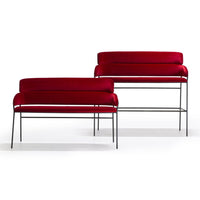 "Set of two sleek benches featuring rich red upholstery and minimalist black metal frames."