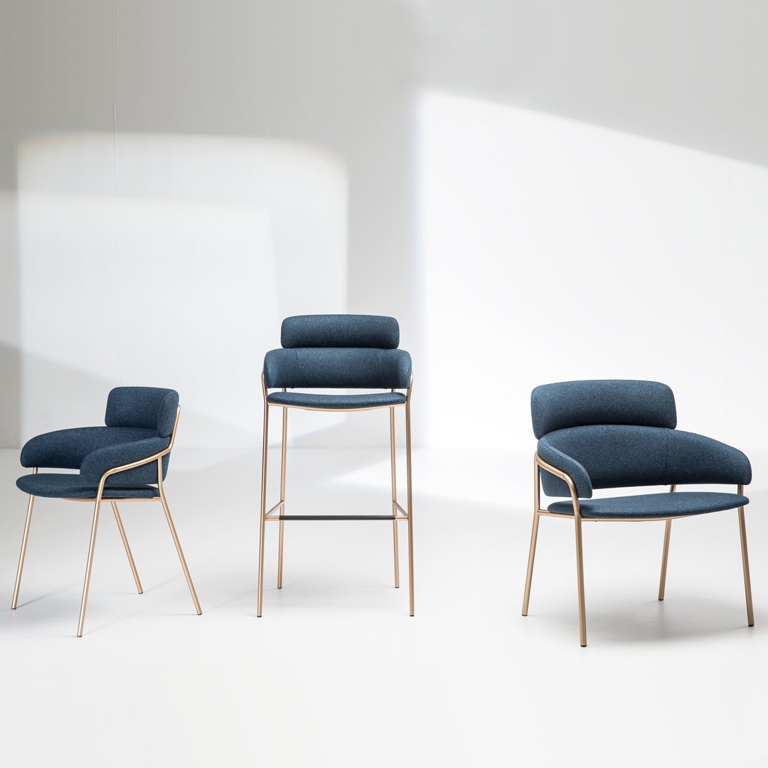 "Set of three chairs featuring deep navy upholstery and sleek gold legs, showcasing a modern, minimalist design."