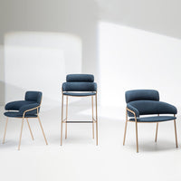 "Set of three chairs featuring deep navy upholstery and sleek gold legs, showcasing a modern, minimalist design."