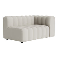 Beige ribbed sofa with a modern curved design and smooth texture, perfect for contemporary interiors.