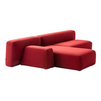 "Modern red sofa in bold geometric shapes and smooth fabric for a contemporary living space."