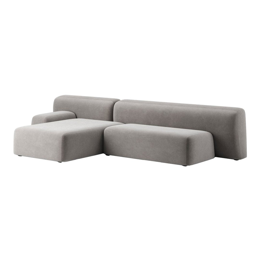 Modern grey sectional sofa with a minimalist design and smooth texture, featuring clean lines and a contemporary shape.