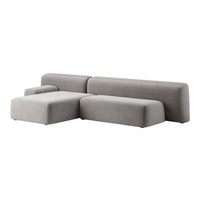 Gray modular sofa with smooth, minimalist design and soft, solid fabric upholstery. Perfect for modern living spaces.