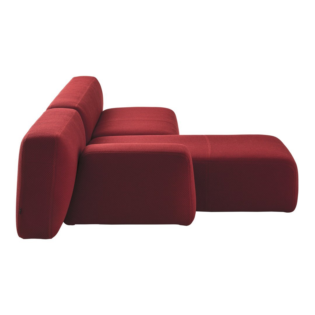 Modern red upholstered couch with a minimalist design and soft, smooth texture. Perfect for stylish interiors.
