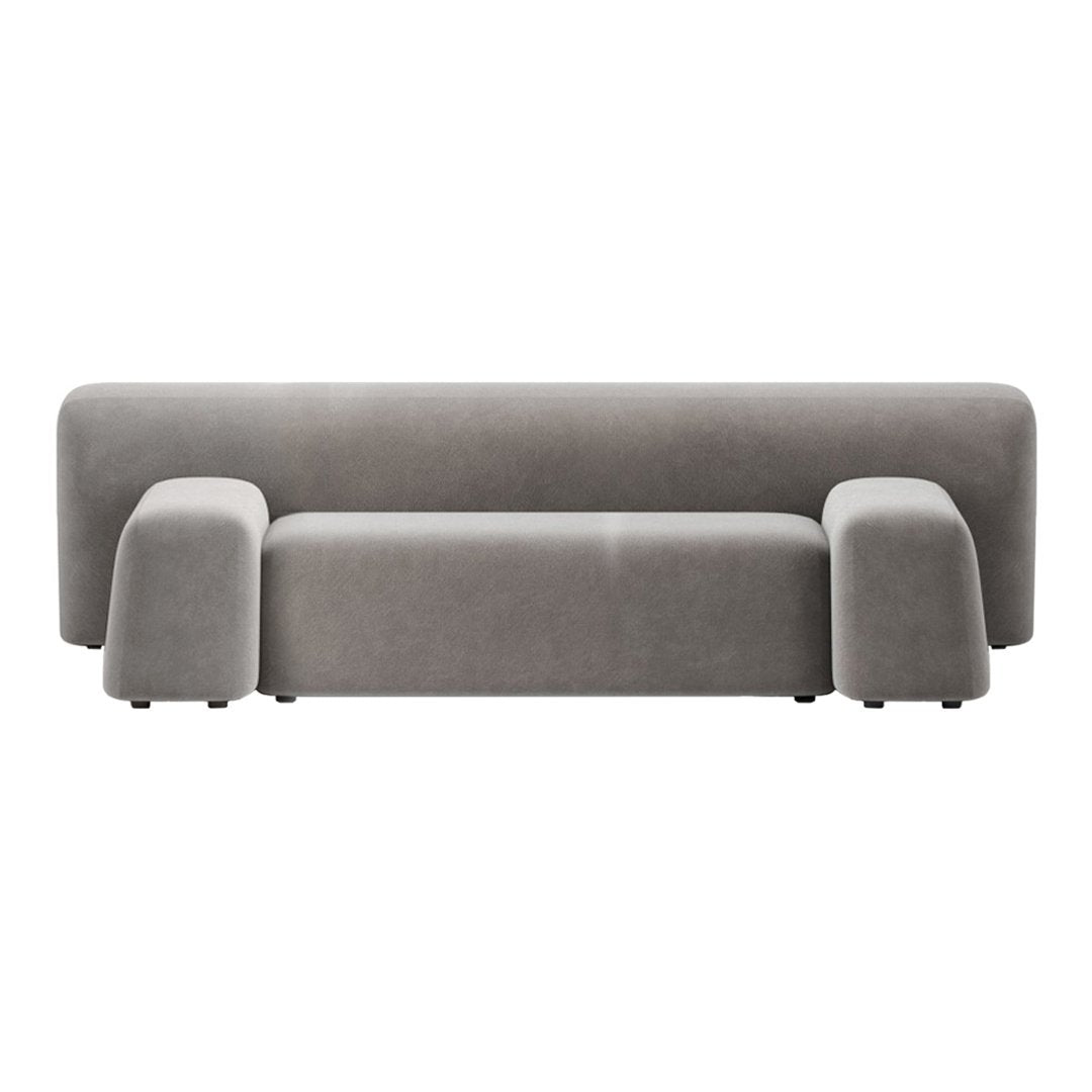 Stylish gray velvet sofa with a minimalistic design and smooth, curved edges for modern decor.