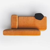 Velvet sofa in rich orange with sleek black accent, featuring modern geometric design. Perfect for stylish interiors.