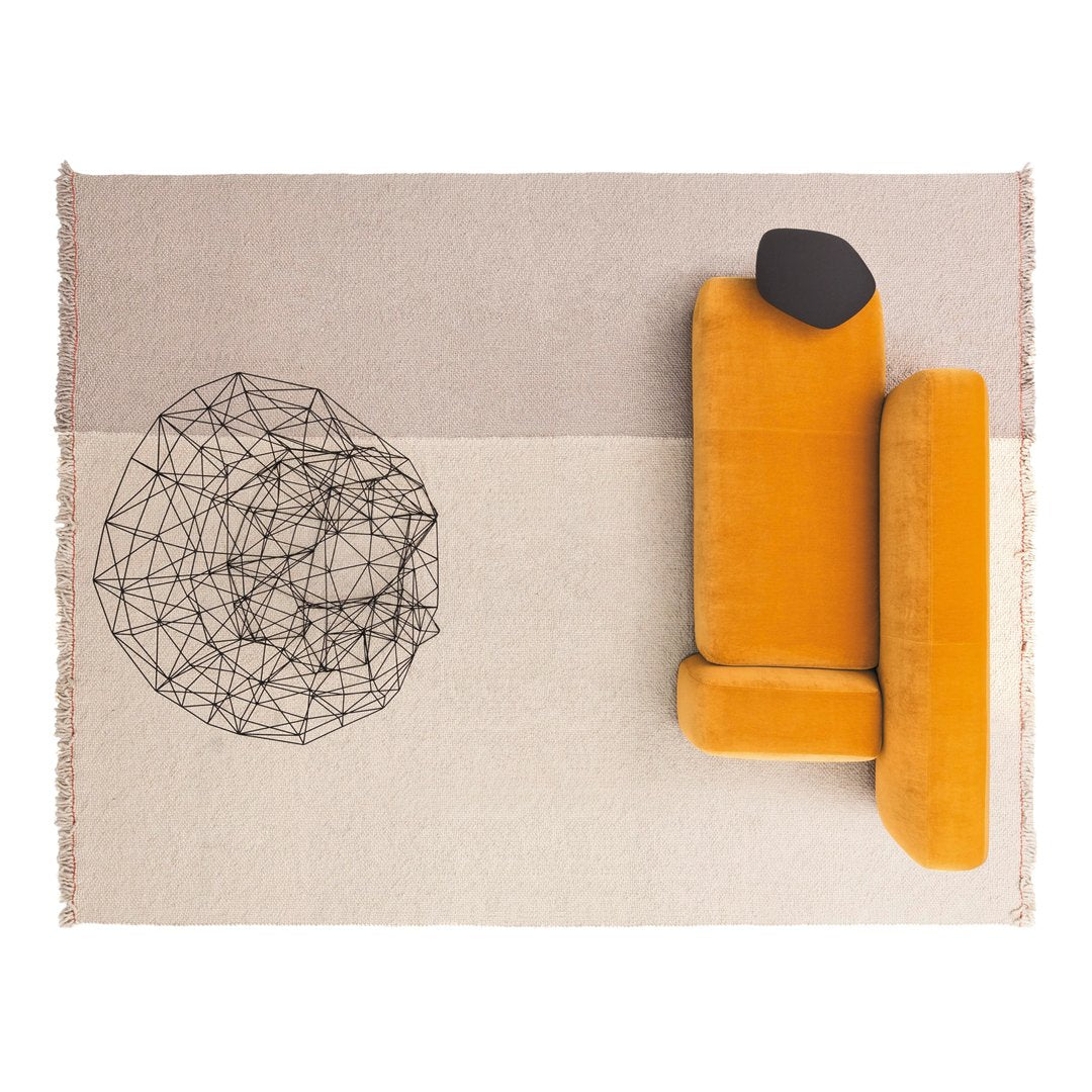 Geometric patterned rug featuring beige, cream, and black colors with a vibrant orange sofa for a stylish contrast.