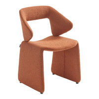 Modern chair in warm terracotta fabric with smooth, minimalist lines and a unique geometric shape. Perfect for contemporary decor.