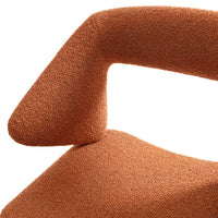 Textured orange upholstery with a modern design, showcasing a unique angled armrest and warm earthy tones.