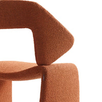 Rust-orange textured upholstery with a geometric pattern in a modern abstract design.