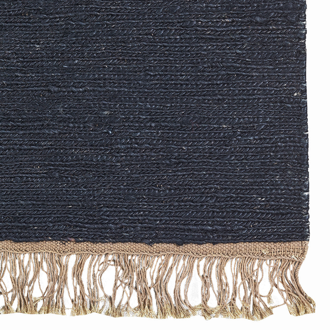 Navy blue textured rug with golden fringes, featuring a subtle woven pattern for an elegant touch.