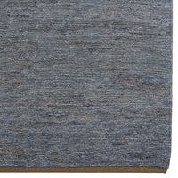 Textured blue area rug featuring subtle variations in shade for a dynamic, modern look. Perfect for any space.