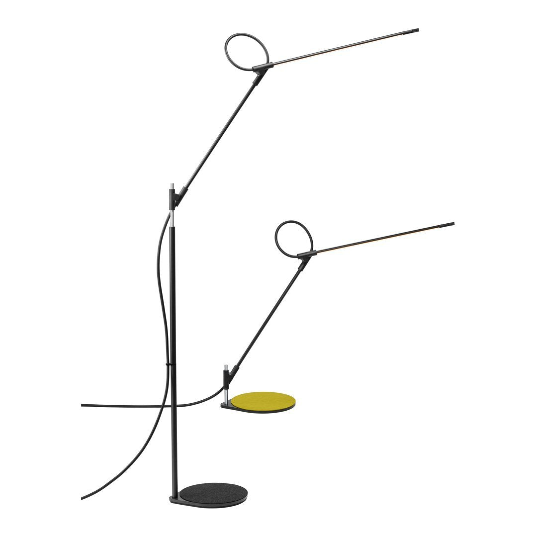 "Modern black lamp with yellow accents and circular design, featuring sleek lines and minimalistic style."