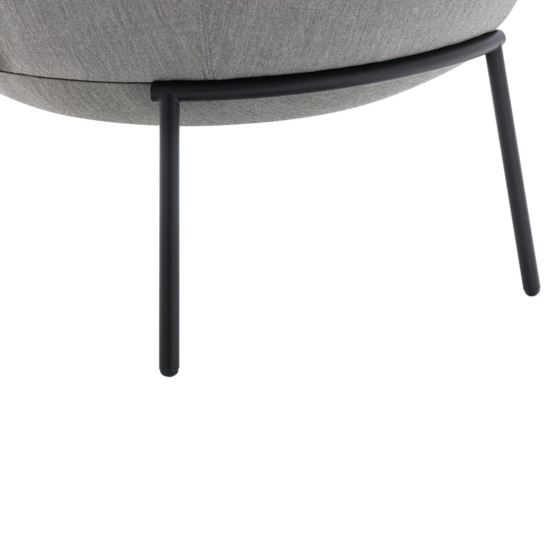 Gray upholstered chair with a smooth texture and sleek black metal legs. Modern design with a minimalist aesthetic.