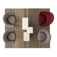 "Modern seating in grey and burgundy with a neutral striped rug, creating a stylish and inviting setting."