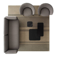 Gray sofa and chairs on a neutral rug with subtle stripes and abstract black geometric patterns.