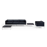 Modern black sofa set with sleek chrome legs, featuring a minimalist design and smooth upholstery.