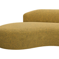 Curved ottoman in warm mustard yellow with a soft, textured finish. Ideal for modern, cozy interiors.
