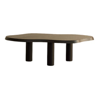 Contemporary coffee table in dark wood with smooth, organic shape and black cylindrical legs.